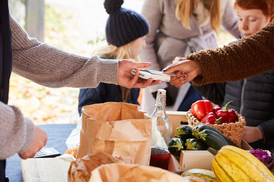 Person paying for groceries with a debit card