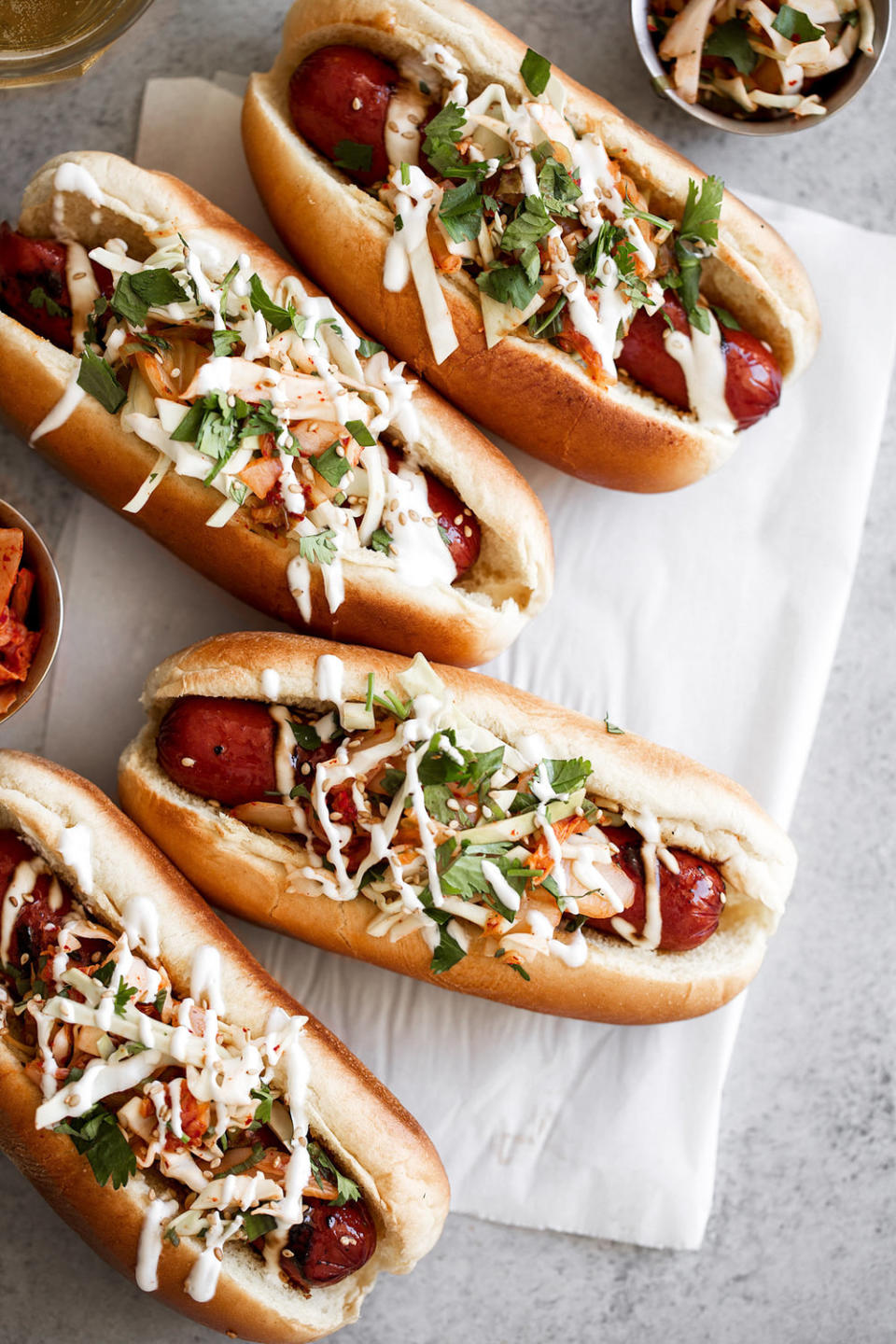 Korean-inspired kimchi hot dogs on buns.