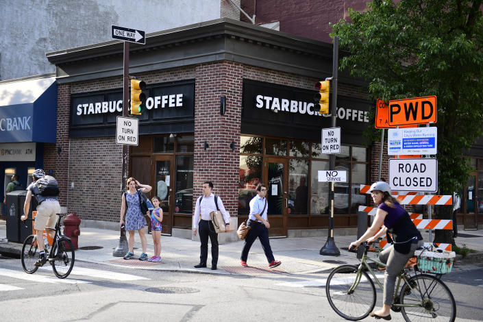 Pedestrians walk by the Starbucks where two black men were arrested a month prior, in the Rittenhouse Square neighborhood of Philadelphia, May 29, 2018. (Corey Perrine/The New York Times)
