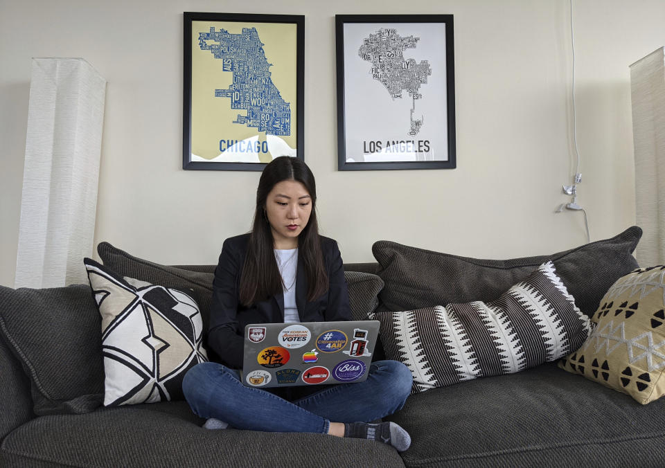 Grace Pai, director of organizing at Chicago’s Asian Americans Advancing Justice branch, works on her computer in her apartment Thursday, March 18, 2021, in Chicago. Pai and others have been busy working with community members as Asian Americans reel from Tuesday’s Atlanta-area shootings by a gunman who killed eight people, six of whom were Asian women. “To think that someone targeted three Asian-owned businesses that were staffed by Asian American women … and didn’t have race or gender in mind is just absurd,” Pai said. (AP Photo/Noreen Nasir)