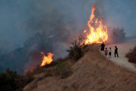 <p>People look on at the La Tuna Canyon fire over Burbank, Calif., Sept. 2, 2017. (Photo: Kyle Grillot/Reuters) </p>