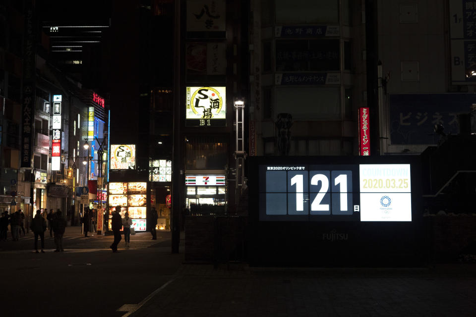 A countdown display shows the remaining days until the Tokyo 2020 Olympics in Tokyo, Wednesday, March 25, 2020. IOC President Thomas Bach has agreed "100%" to a proposal of postponing the Tokyo Olympics for about one year until 2021 because of the coronavirus outbreak, Japanese Prime Minister Shinzo Abe said Tuesday. (AP Photo/Jae C. Hong)