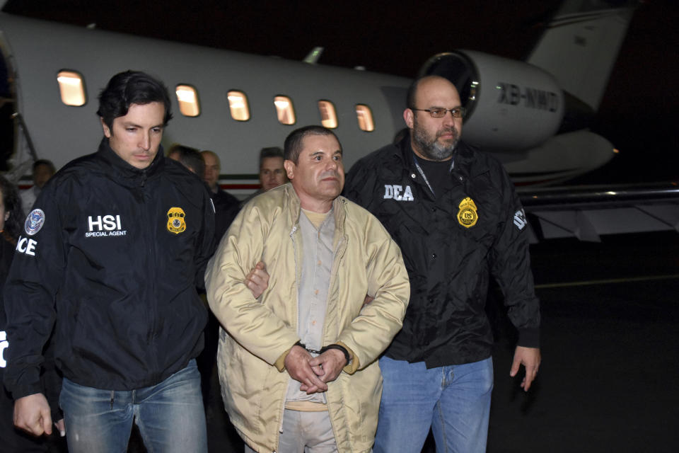 FILE - In this Jan. 19, 2017 file photo provided U.S. law enforcement, authorities escort Joaquin "El Chapo" Guzman, center, from a plane to a waiting caravan of SUVs at Long Island MacArthur Airport, in Ronkonkoma, N.Y. A jury has been picked for the U.S. trial of the Mexican drug lord. Seven women and five men were selected Wednesday, Nov. 7, 2018, as jurors in the case against Guzman. The trial is set to begin Nov. 13 with opening statements in federal court in Brooklyn. (U.S. law enforcement via AP, File)