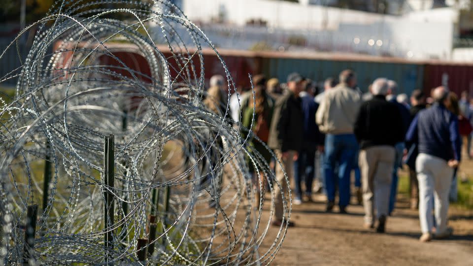 Members of Congress tour an area lined with concertina wire in Eagle Pass on January 3, a week before Texas blocked Border Patrol agents from parts of the city. - Eric Gay/AP