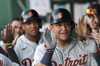 Detroit Tigers' Miguel Cabrera, front, celebrates with teammates, including Jonathan Schoop, behind, after they scored two runs during the first inning of a baseball game against the Kansas City Royals in Kansas City, Mo., Monday, June 14, 2021. (AP Photo/Reed Hoffmann)