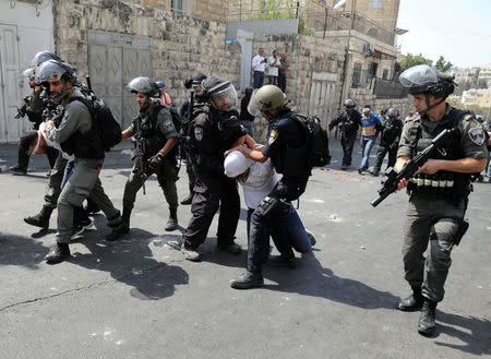 Israeli security forces arrest Palestinian men following clashes outside Jerusalem's Old city July 21, 2017. REUTERS/Ammar Awad