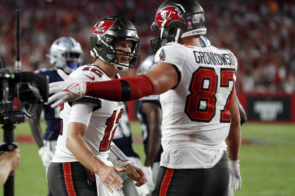 Tampa Bay Buccaneers quarterback Tom Brady (12) celebrates with tight end Rob Gronkowski (87) after Gronkowski caught a 2-yard touchdown pass during the first half of an NFL football game Thursday, Sept. 9, 2021, in Tampa, Fla. (AP Photo/Scott Audette)