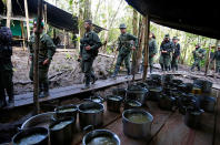 <p>Members of the 51st Front of the Revolutionary Armed Forces of Colombia (FARC) stand in line to get food at a camp in Cordillera Oriental, Colombia, August 16, 2016. (John Vizcaino/Reuters) </p>