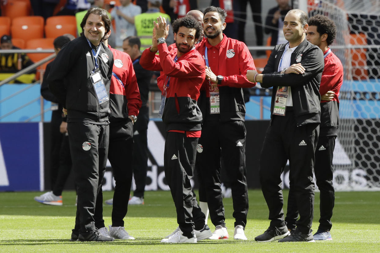 Egypt’s Mohamed Salah, center, waves to supporters as he arrives for the group A match between Egypt and Uruguay at the 2018 soccer World Cup in the Yekaterinburg Arena in Yekaterinburg, Russia, Friday, June 15, 2018. (AP Photo/Mark Baker)