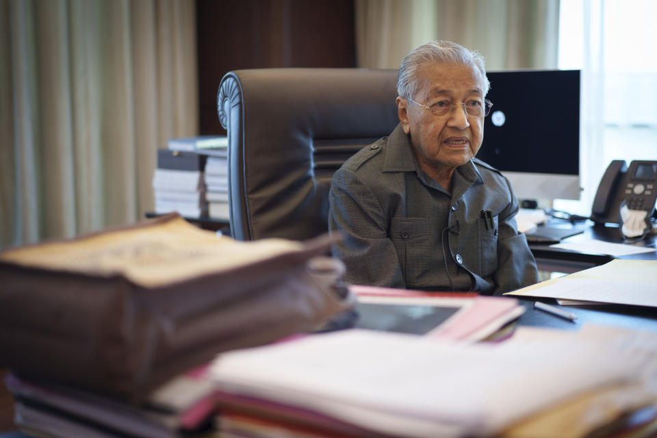 Malaysia's former Prime Minister Mahathir Mohamad speaks during an interview with The Associated Press at his office in Kuala Lumpur, Malaysia, Friday, Aug. 19, 2022. Mahathir expects Malaysia’s graft-tainted ruling party will hold general elections in coming months, and could win big, but the nonagenarian reformer vowed Friday that he would fight "even a losing battle" on principle. (AP Photo/Vincent Thian)