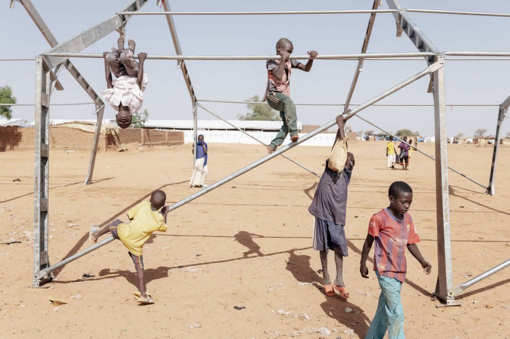 Children play on a metal structure inside the Adrè refugee camp. UNICEF has reported that almost four million children in Sudan face acute malnutrition, and within refugee sites in Chad such as Adrè, budget cuts mean that residents have seen their food rations reduced.<span class="copyright">Nicolò Filippo Rosso</span>