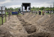 Open graves for unidentified civilians murdered by the Russian troops during Russian occupation are seen in Bucha, on the outskirts of Kyiv, Ukraine, Thursday, Aug. 11, 2022. Eleven unidentified bodies exhumed from a mass grave were buried in Bucha Thursday.(AP Photo/Efrem Lukatsky)