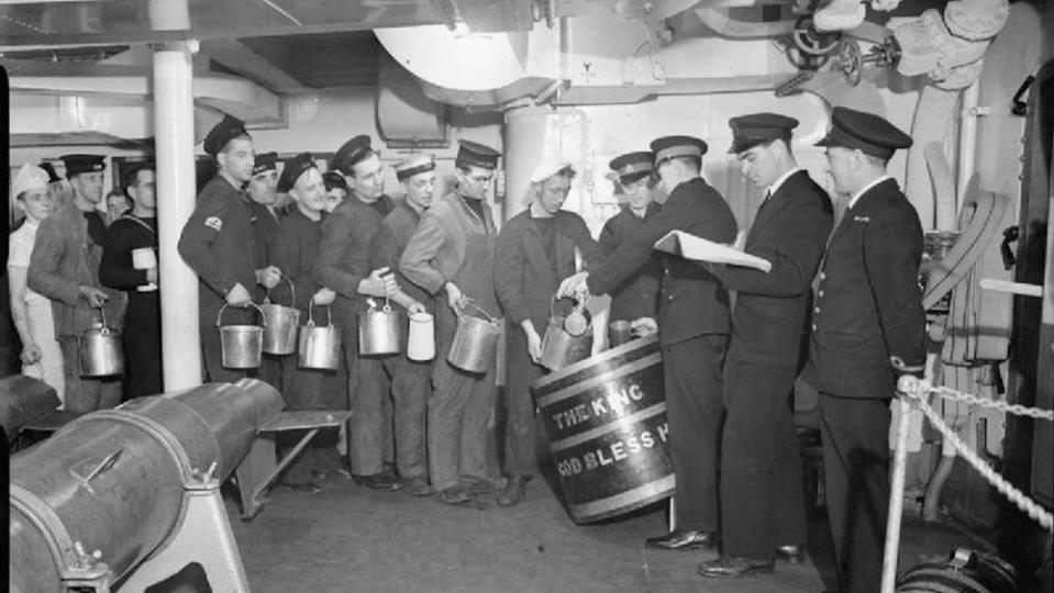 Sailors getting their ration of rum. - Credit: Photo: courtesy Beadell, S J (Lt), Royal Navy official photographer/Wikimedia Commons