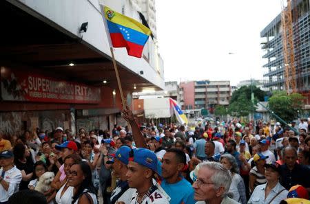 Opposition supporters wait near a polling station for results of an unofficial plebiscite against President Nicolas Maduro's government and his plan to rewrite the constitution, in Caracas, Venezuela July 16, 2017. REUTERS/Marco Bello