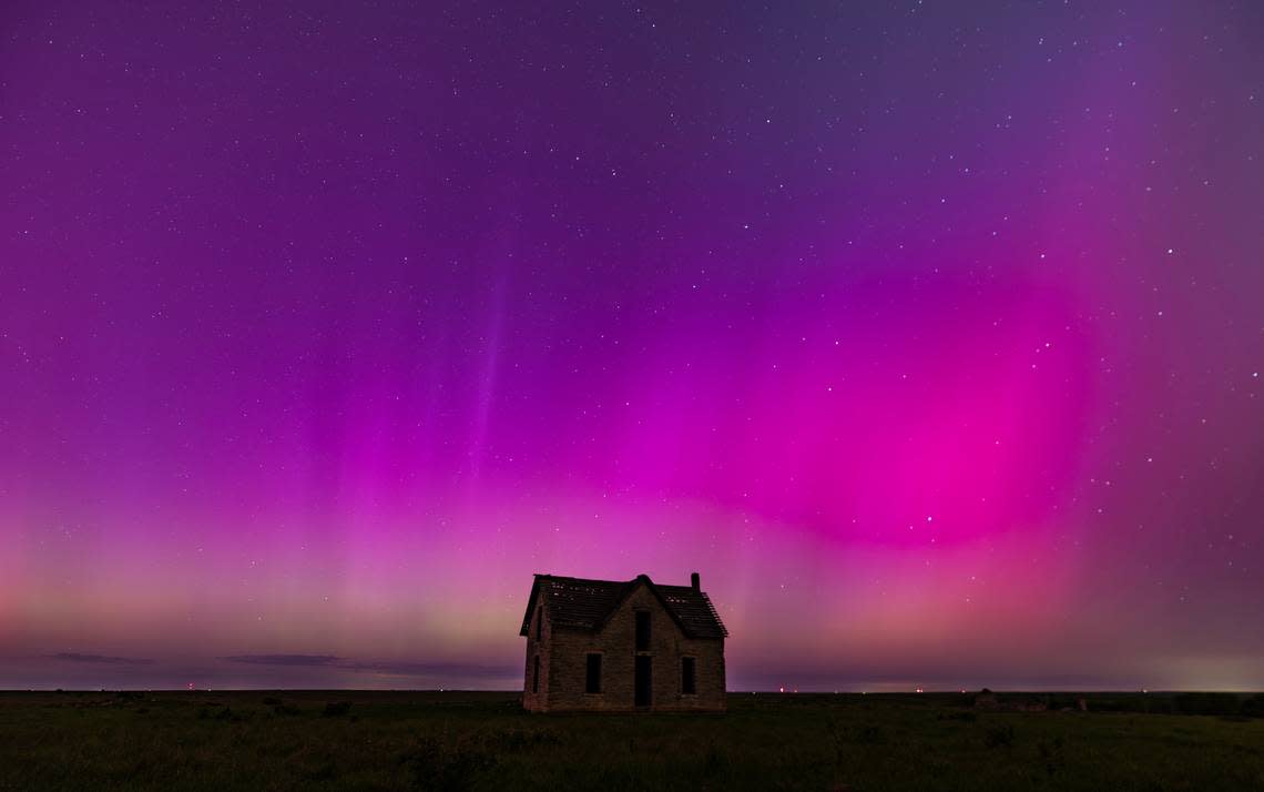The aurora borealis can be seen in the northern sky near the Marion and Chase County line on Friday night. The abandoned stone limestone house in the pasture was built in 1878.