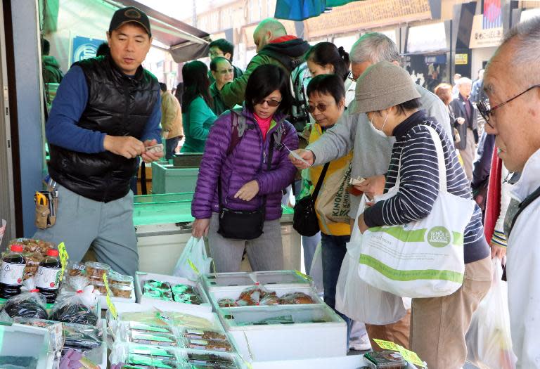 Shoppers buy dried food at a market in Tokyo on March 27, 2015