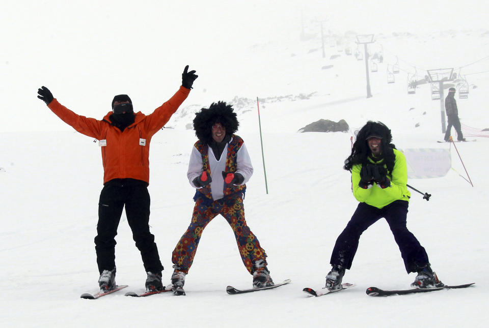 People react on the slopes, at the ski resort Porte Puymorens, in southwestern France, Saturday, June 1, 2013. The still-white slopes in the Pyrenees of southern France opened for business on Saturday, turning a cold damp spring into an rare June ski weekend. The Porte-Puymorens ski station opened Saturday morning at 8 a.m. for four hours in fog and light rain _ but plenty of snow with temperatures just above freezing. (AP Photo/Bob Edme)