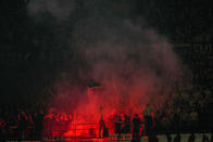 AC Milan supporters light flares during the Europa League quarterfinal first leg soccer match between AC Milan and Roma at the San Siro Stadium, in Milan, Italy, Thursday, April 11, 2024. (AP Photo/Antonio Calanni)