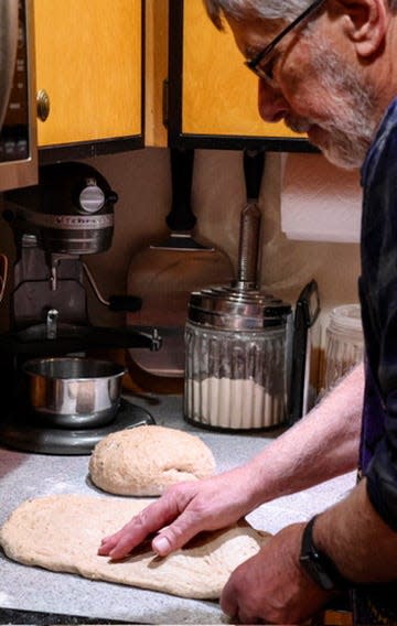 John Haskin, a volunteer baker of Community Loaves bakes loaves for local food banks at his kitchen on Bainbridge Island.