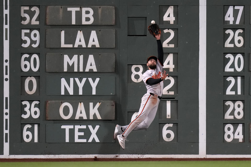 Baltimore Orioles outfielder Colton Cowser makes the catch on a fly out by Boston Red Sox's Romy Gonzalez during the eighth inning of a baseball game, Wednesday, April 10, 2024, in Boston. (AP Photo/Charles Krupa)