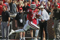 Oklahoma wide receiver CeeDee Lamb (2) looks over his shoulder as he carries the ball in for a touchdown in the second quarter of an NCAA college football game against Texas Tech in Norman, Okla., Saturday, Sept. 28, 2019. (AP Photo/Sue Ogrocki)