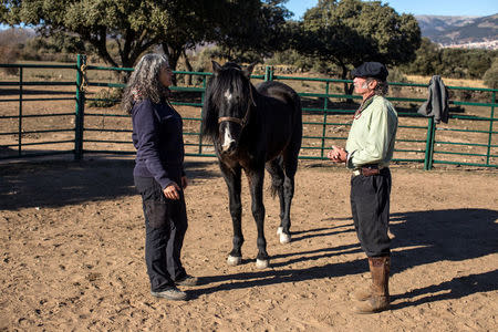 Fernando Noailles, emotional therapist, and his patient Loreto Garcia attend an emotional therapy session with a horse named Madrid in Guadalix de la Sierra, outside Madrid, Spain, December 4, 2017. Noailles uses his animals to help people suffering from stress and anxiety. REUTERS/Juan Medina