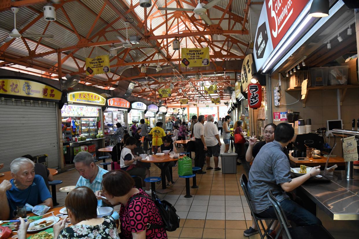 People have their lunch at the Maxwell hawker centre, illustrating a story on the Great Budget Meal Hunt.