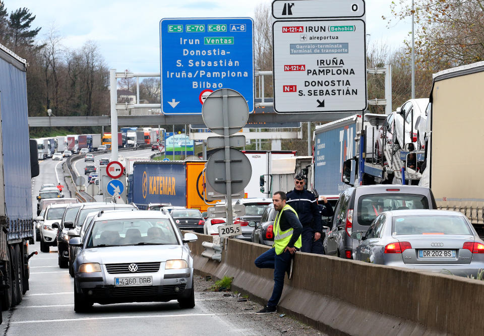 Demonstrators wearing yellow vests on the blocked highway near the French border with Spain, during a protest Saturday, Dec. 15, 2018 in Biriatou, southwestern France. Police have deployed in large numbers Saturday for the fifth straight weekend of demonstrations by the "yellow vest" protesters, with authorities repeating calls for calm after protests on previous weekends turned violent. (AP Photo/Bob Edme)