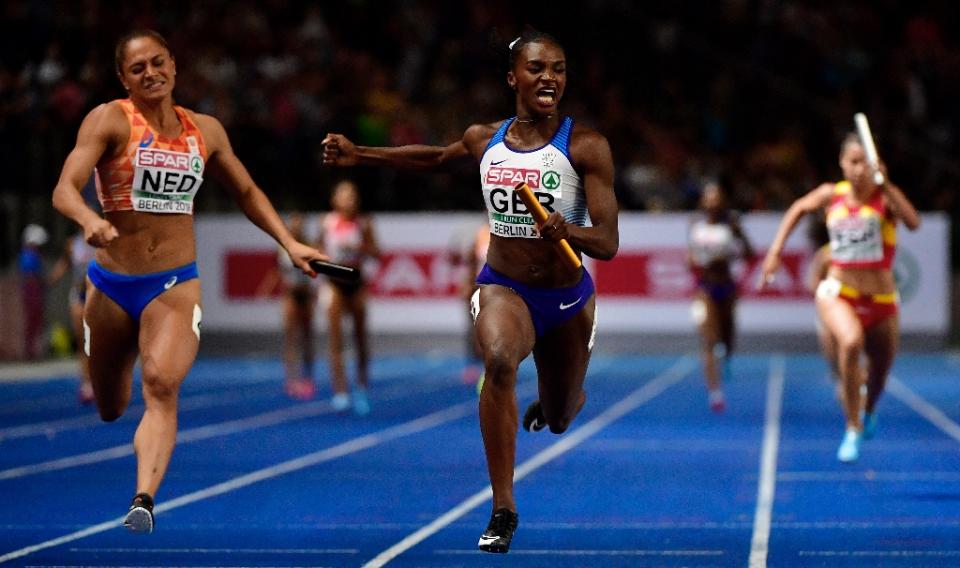 Dina Asher-Smith powers to her third gold medal in the 4x100m relay (AFP Photo/John MACDOUGALL)