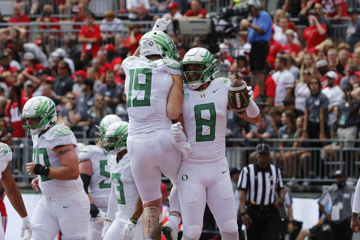 Oregon tight end Moliki Matavao, right, celebrates his touchdown against Ohio State with tight end Terrance Ferguson during the second half of an NCAA college football game Saturday, Sept. 11, 2021, in Columbus, Ohio. Oregon beat Ohio State 35-28. (AP Photo/Jay LaPrete)