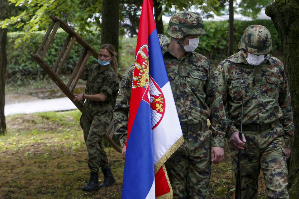 FILE - Serbian Army soldiers prepare for a welcoming ceremony for Serbian President Aleksandar Vucic during COVID-19 vaccination at the army barracks in Belgrade, Serbia, on May 13, 2021. Serbia looks set to reintroduce the obligatory military service for its young citizens, the army command said Thursday, Jan. 4, 2024 in a move that comes amid rising tensions in the Balkans. (AP Photo/Darko Vojinovic, File)
