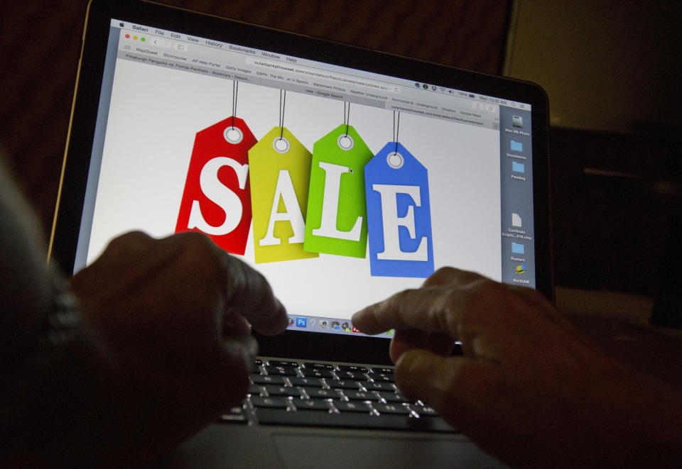 FILE -In this Dec. 12, 2016, photo, a person searches the internet for sales, in Miami. Consumers are scouring the internet for online deals as they begin to cap off the five-day post-Thanksgiving shopping bonanza with Cyber Monday. Cyber Monday –- a term coined back in 2005 by the National Retail Federation –- continues to be the biggest online shopping day of the year, thanks to the deals and the hype the industry has created to fuel it. (AP Photo/Wilfredo Lee, File)