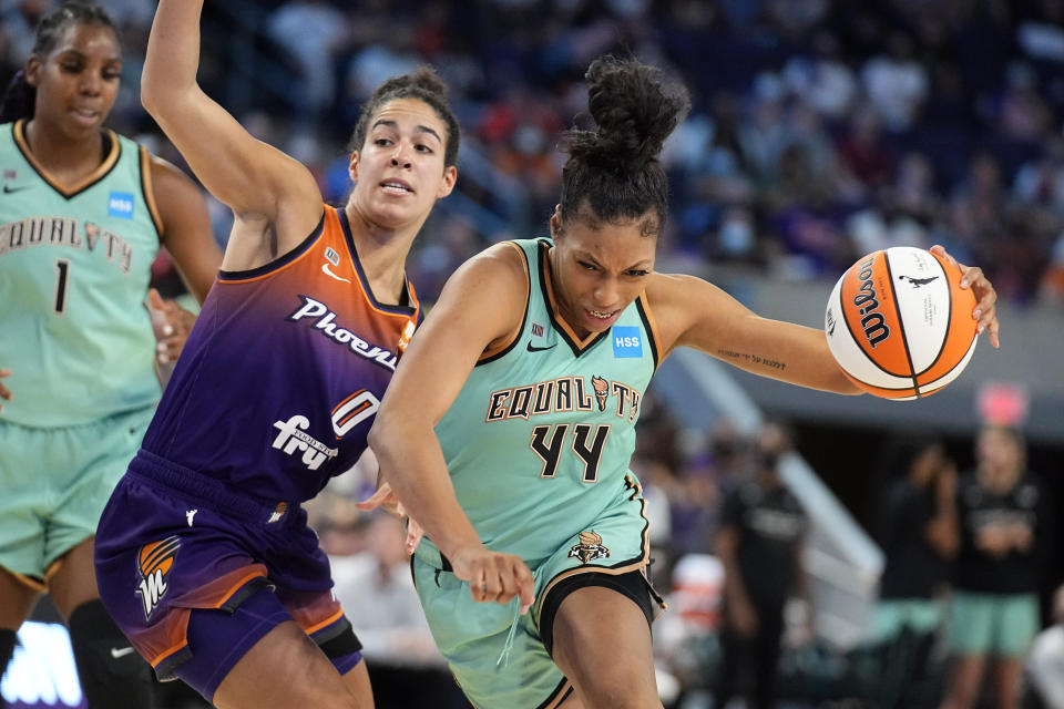 New York Liberty guard/forward Betnijah Laney (44) drives past Phoenix Mercury guard Kia Nurse (0) during the second half in the first round of the WNBA basketball playoffs, Thursday, Sept. 23, 2021, in Phoenix. Phoenix won 83-82. (AP Photo/Rick Scuteri)