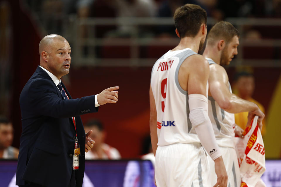 In this Saturday, Aug. 31, 2019 photo, Poland's head coach Mike Taylor talks to his team during their group phase basketball game against Venezuela in the FIBA Basketball World Cup at the Cadillac Arena in Beijing. American coach Mike Taylor led Poland to its first World Cup victory in 52 years in the first game against Venezuela. Now he'll try to upset host China in the second game on Monday. (AP Photo/Mark Schiefelbein)