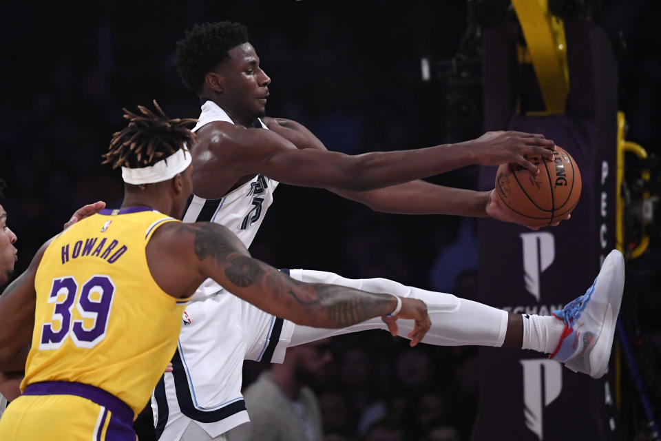 Memphis Grizzlies forward Jaren Jackson Jr., right, grabs a rebound away from Los Angeles Lakers center Dwight Howard during the first half of an NBA basketball game Friday, Feb. 21, 2020, in Los Angeles. (AP Photo/Mark J. Terrill)
