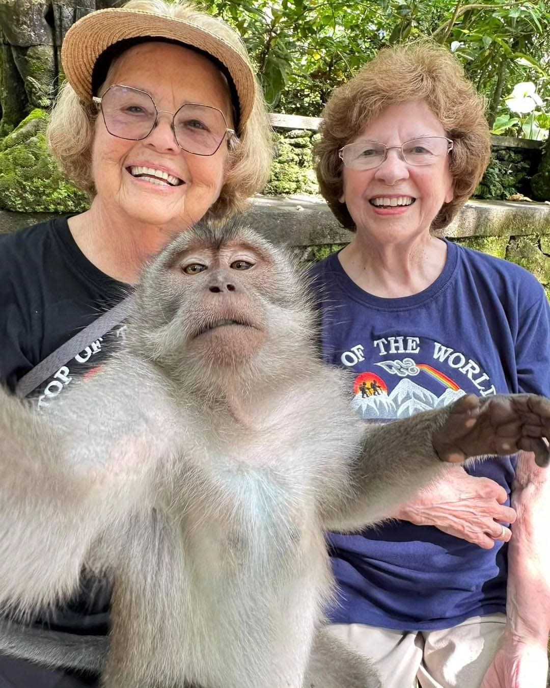 Best friends Ellie Hamby, left, and Sandra Hazelip take a selfie with a long-tailed macaque monkey in Padangtegal Ubud, Bali, on March 15.