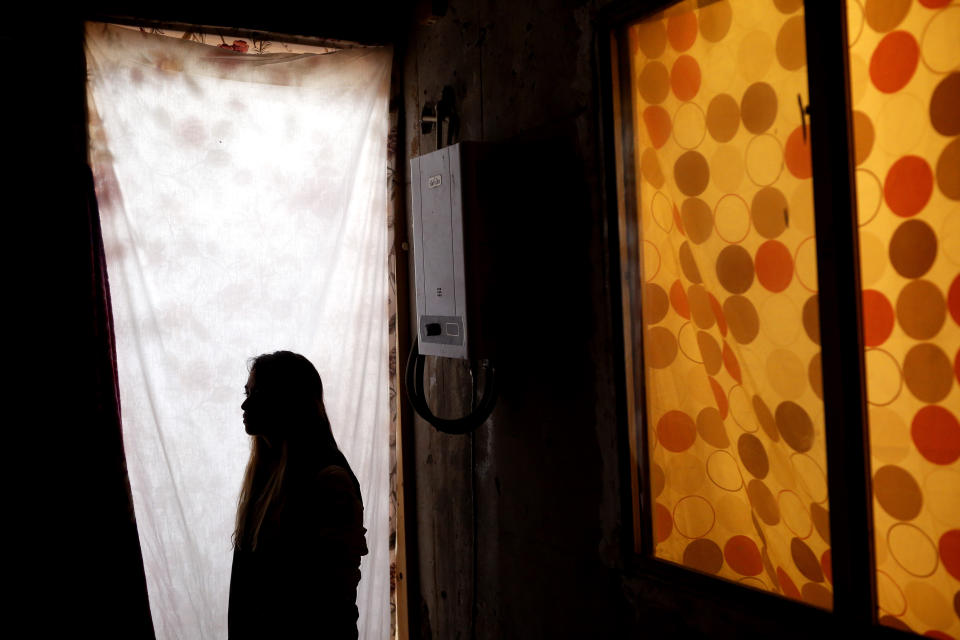 In this Tuesday, Nov. 5, 2019, photo, Lizbeth poses for a portrait in a relative's home in Tijuana, Mexico. Lizbeth, a Salvadoran woman seeking asylum in the United States, never thought she would be returned to Mexico to wait for the outcome of her case, after suffering multiple assaults, and being kidnapped into prostitution on her journey through Mexico. Critics of the Trump administration's "Migrant Protection Protocols" policy, say it denies asylum seekers fair and humane treatment, largely by forcing them to wait in a country plagued by large pockets of drug-fueled violence, demonstrated this week by the slaughter near the U.S. border of several children and women. (AP Photo/Gregory Bull)