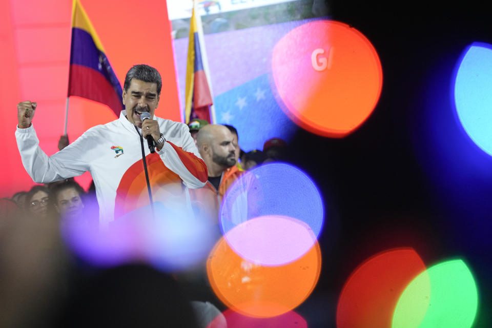 President Nicolas Maduro speaks to pro-government supporters after a referendum regarding Venezuela's claim to the Essequibo, a region administered and controlled by Guyana, in Caracas, Venezuela, Sunday, Dec. 3, 2023. Voters answered five questions about the future of the disputed land, including whether they support turning it into a Venezuelan state. (AP Photo/Matias Delacroix)