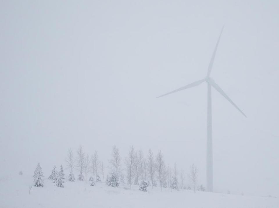 A wind turbine among snow covered trees near Beaver Dam, Wisconsin.