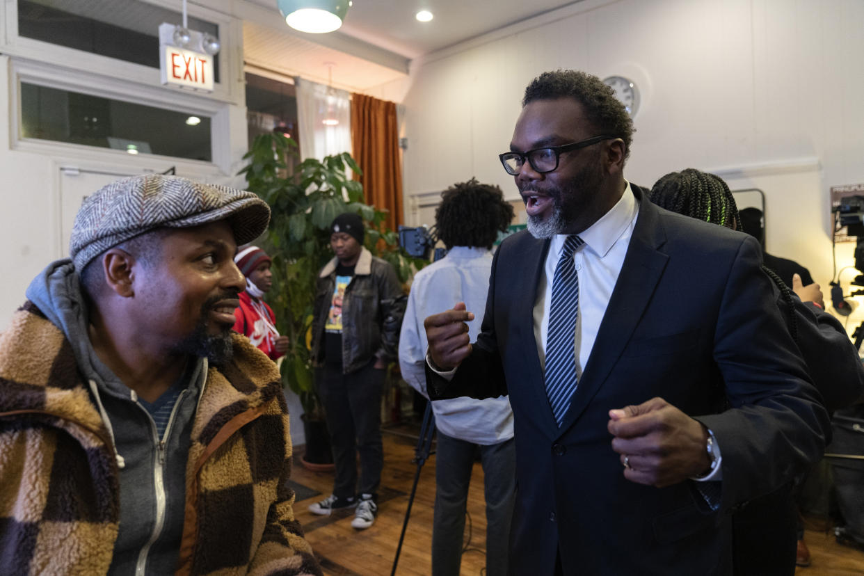 FILE - Chicago mayoral candidate Brandon Johnson, right, speaks with owner Bobby Price Chicago during a public listening session at Principle Barbers, Monday, Dec. 19, 2022, in the North Lawndale neighborhood of Chicago. Johnson is endorsed by the Chicago Teachers Union, a group that has tangled with Chicago mayor Lori Lightfoot, including during an 11-day teachers strike during her first year in office. (AP Photo/Erin Hooley, File)