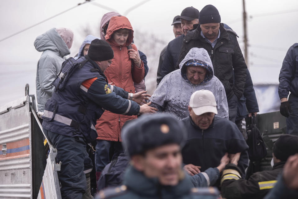 Emergency workers help local residents to deboard an amphibian vehicle during evacuations in a flooded street after parts of a dam burst, in Orsk, Russia on Monday, April 8, 2024. Floods caused by rising water levels in the Ural River broke a dam in a city near Russia's border with Kazakhstan, forcing some 2,000 people to evacuate, local authorities said. The dam broke in the city of Orsk in the Orenburg region, less than 12.4 miles north of the border on Friday night, according to Orsk mayor Vasily Kozupitsa. (AP Photo)