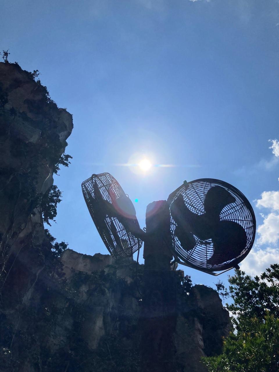 Huge fans provide a breeze as parkgoers make their way toward the Flight of Passage entrance at Walt Disney World's Animal Kingdom.