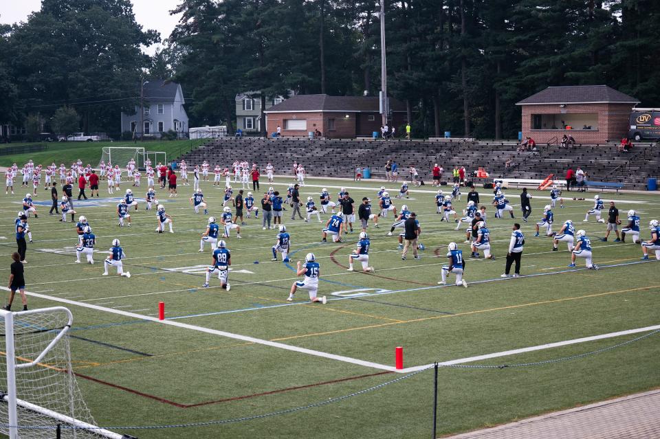 Players from the Leominster and St. John's football teams warm up Friday Sept. 8 at Doyle Field.