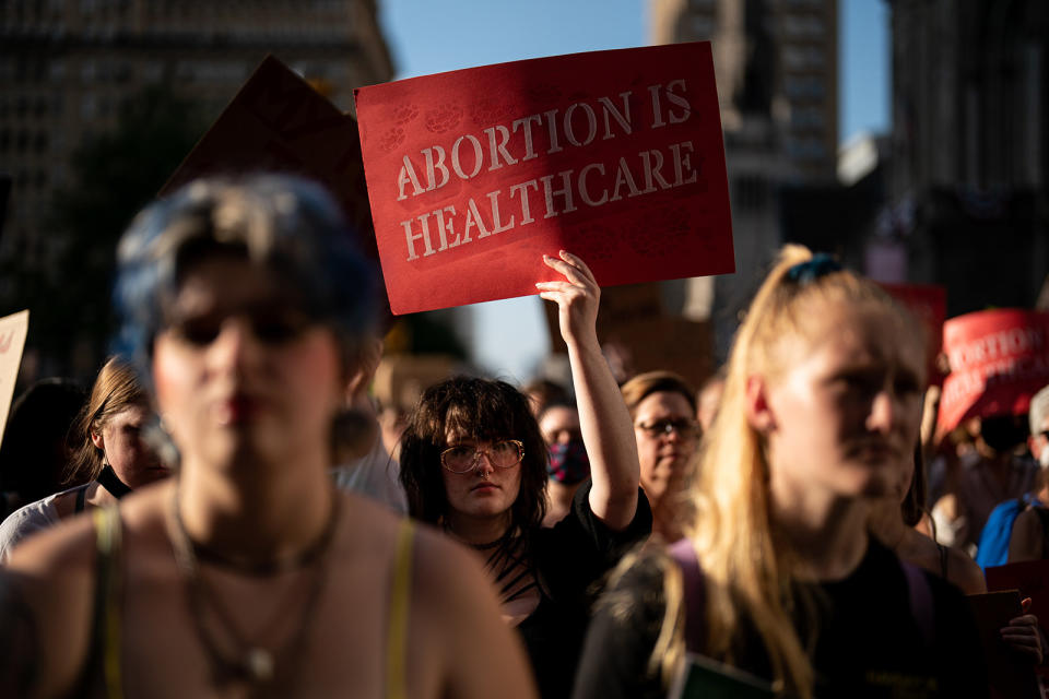 Person in a crowd of protesters holds up sign "Abortion is healthcare"