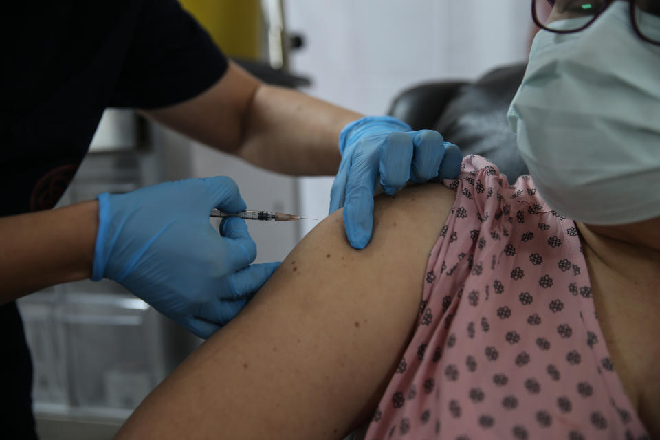 ANKARA, TURKEY - OCTOBER 27: A health care worker injects the a syringe of the phase 3 vaccine trial, to a volunteer at the Ankara University Ibni Sina Hospital in Ankara, Turkey on October 27, 2020. This vaccine candidate developed against the novel coronavirus (COVID-19) pandemic by the U.S. Pfizer and German BioNTech company. (Photo by Dogukan Keskinkilic/Anadolu Agency via Getty Images)