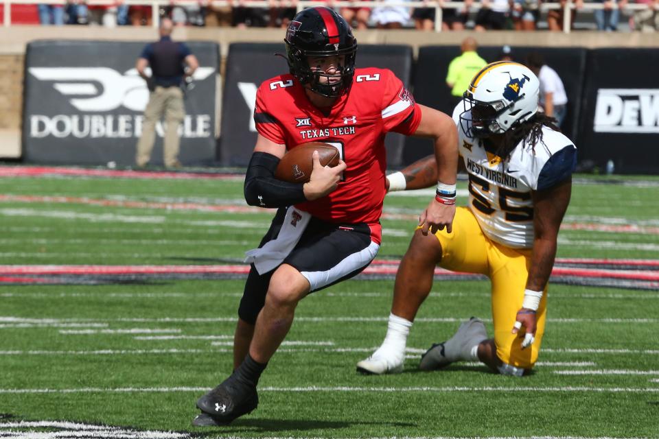 Texas Tech Red Raiders quarterback Behren Morton (2) rushes against West Virginia Mountaineers defensive tackle Dante Stills (55) in the first half at Jones AT&T Stadium and Cody Campbell Field.