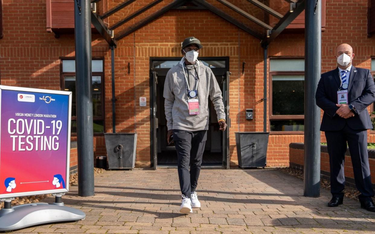 Kenya's Eliud Kipchoge walks out of the COVID-19 testing area after arriving at the official hotel  - PA