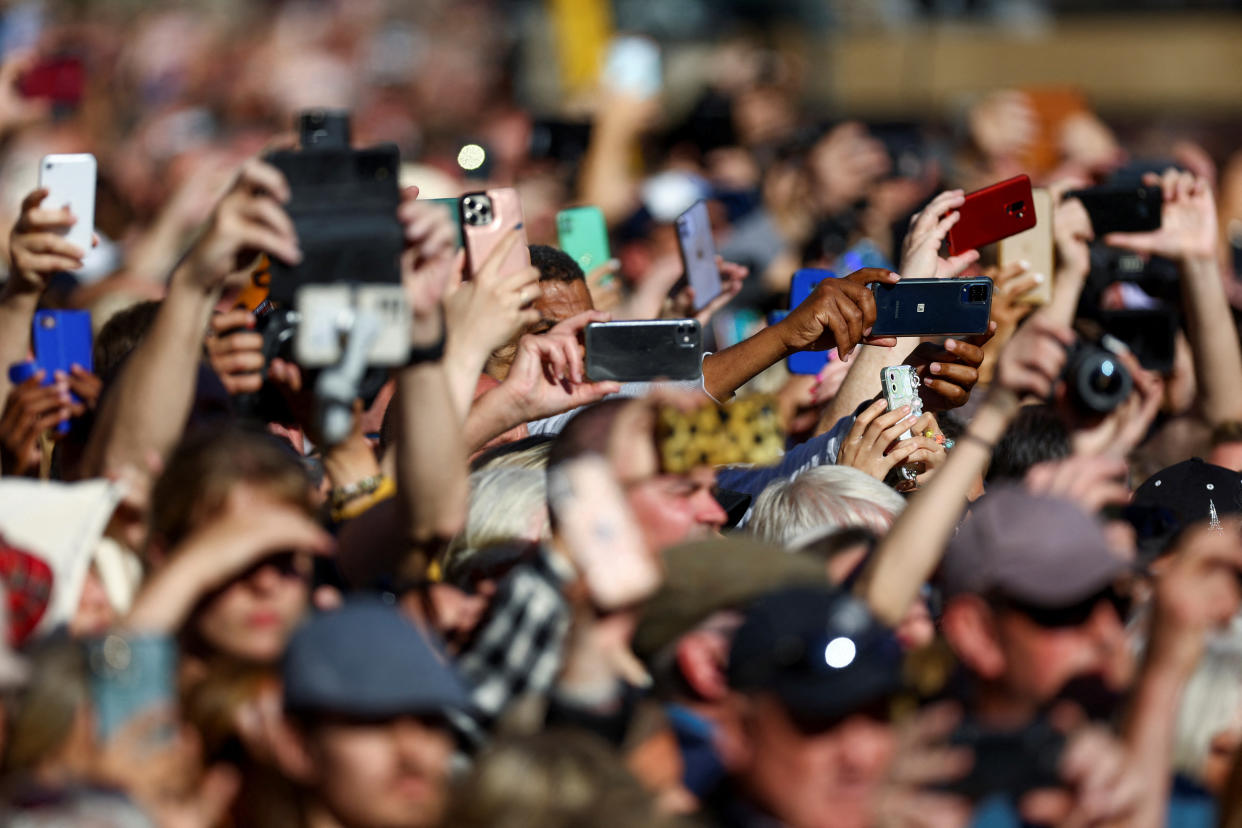 Mobile phones People with phones in the crowd as they wait outside St Giles' Cathedral to see Queen Elizabeth's coffin, following the death of Britain's Queen Elizabeth, in Edinburgh, Scotland, Britain, September 13, 2022.  REUTERS/Hannah McKay