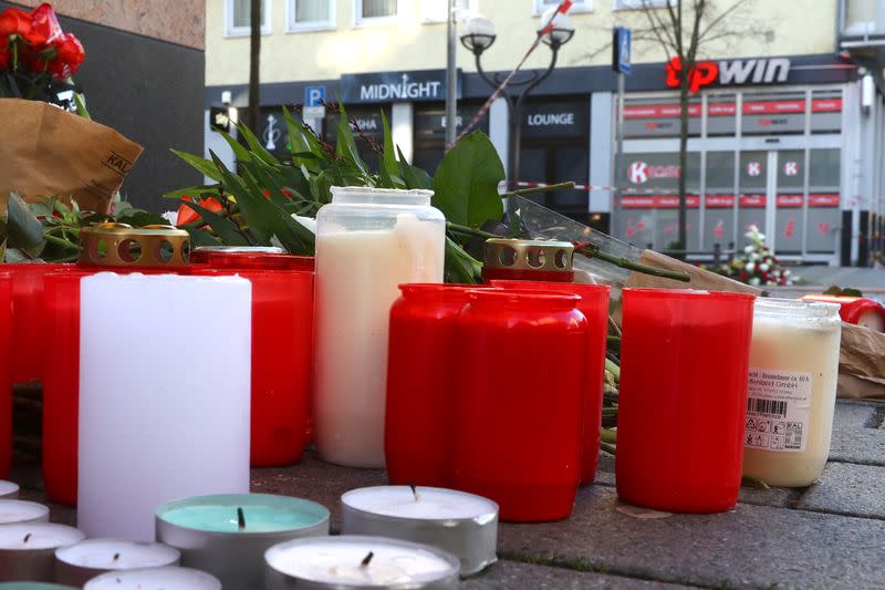 Candles and flowers are seen placed outside the Midnight Shisha bar, for the victims of a shooting in Hanau