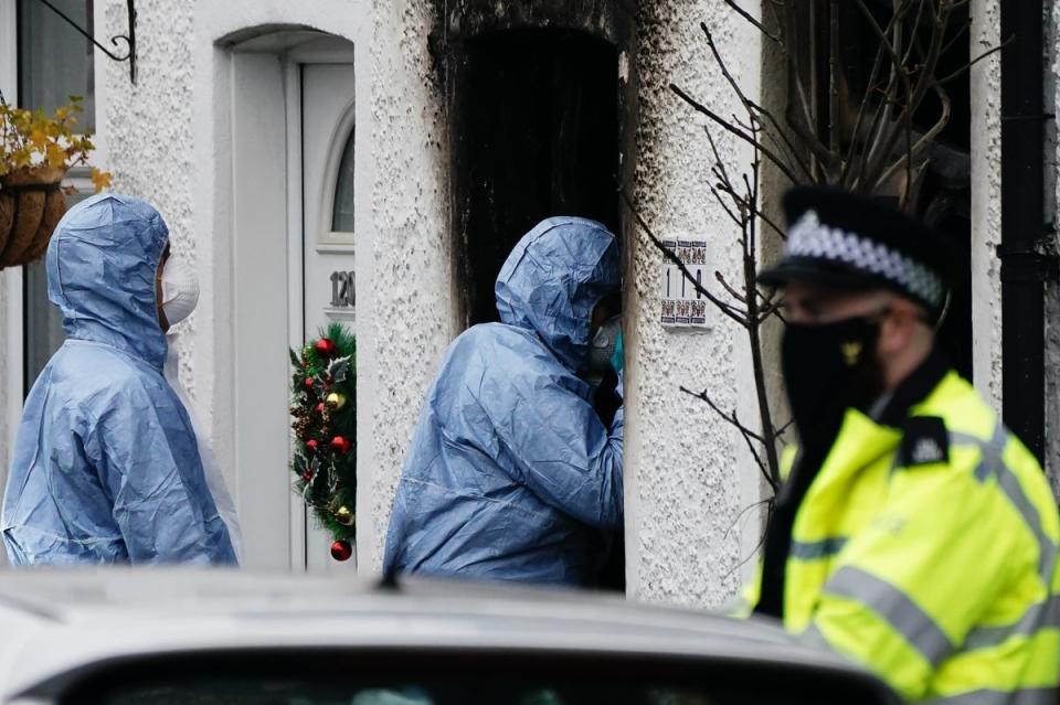 Forensic investigators at the scene in Collingwood Road, Sutton, south London (PA Wire)